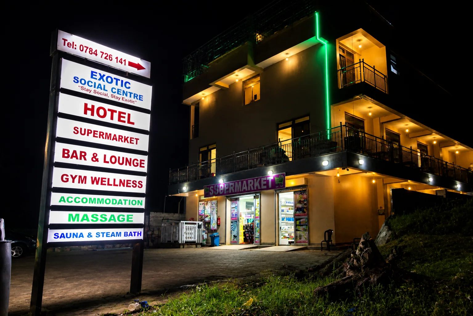 Night exterior with roadside service sign
